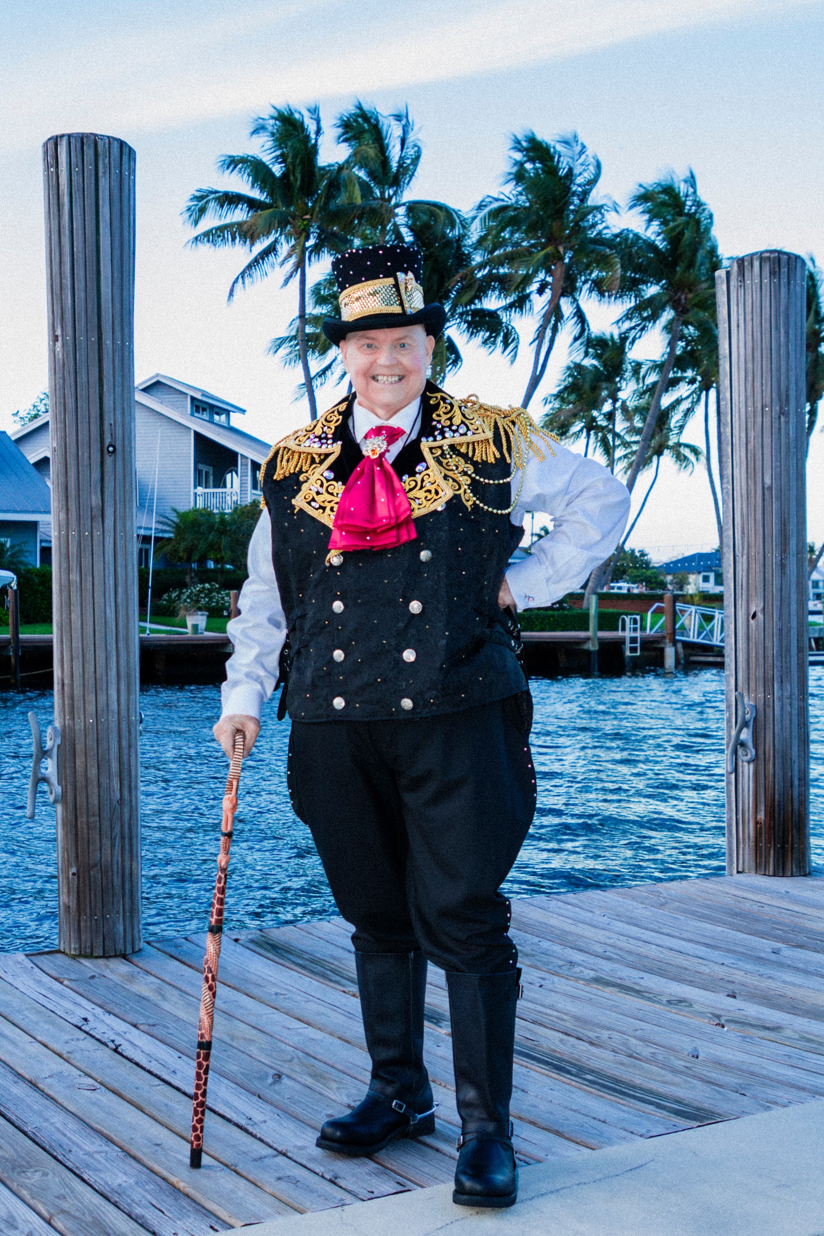 James in ornate costume on waterfront dock