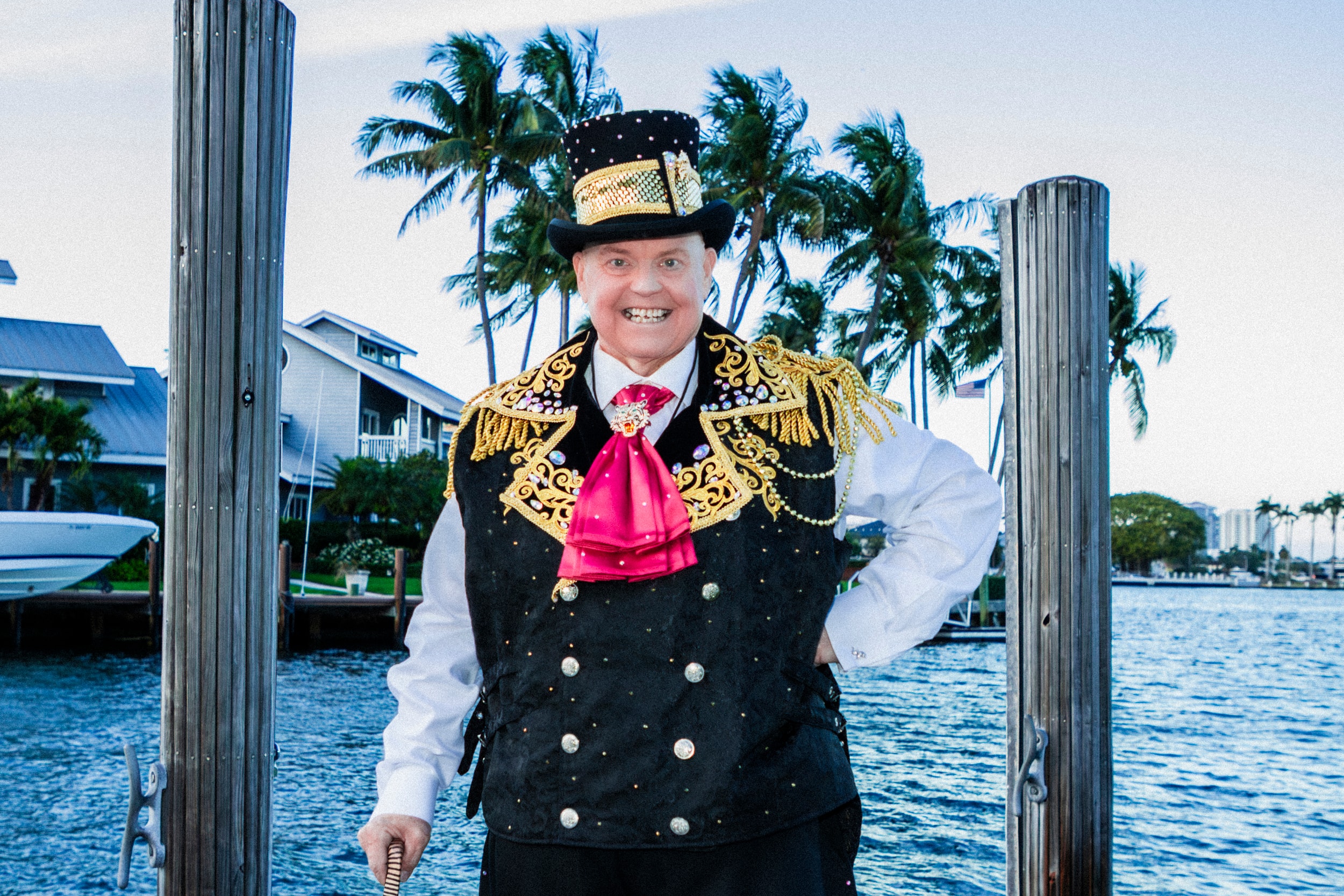 James Tiny Lambros in ornate costume on dock