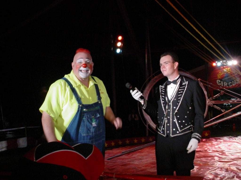 Clown and ringmaster performing at circus