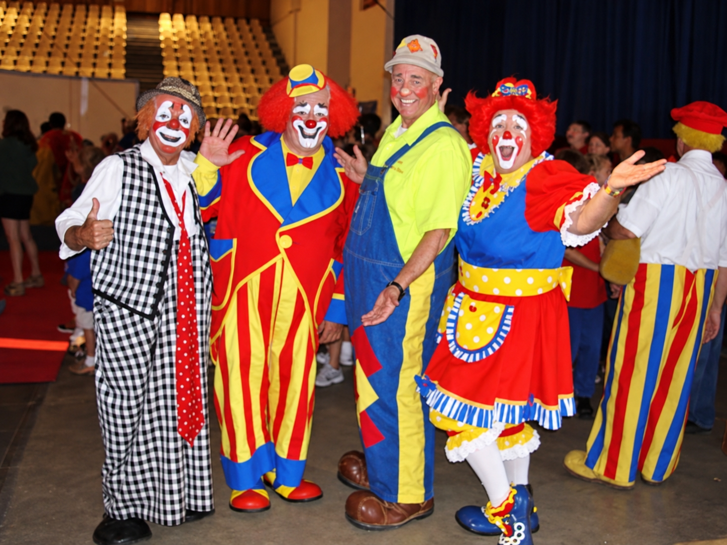 Four clowns posing together at circus event